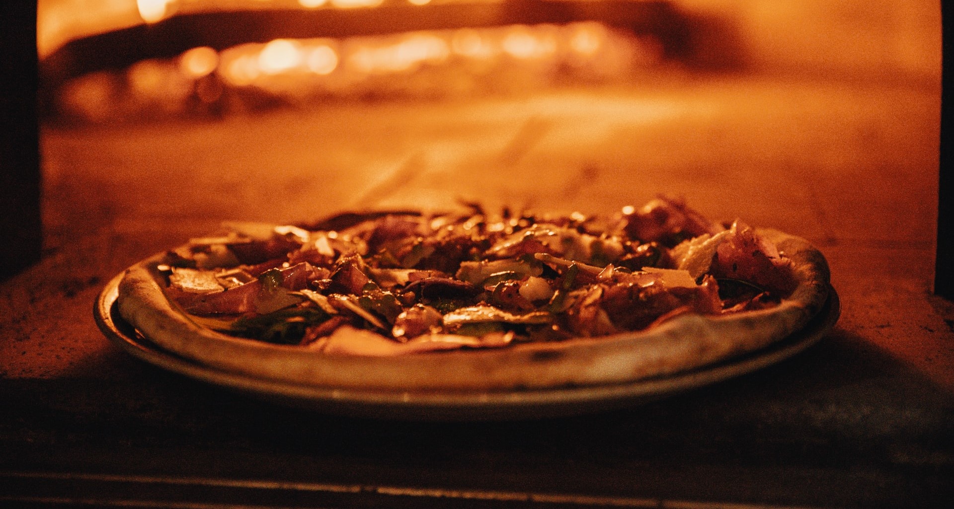 pizza in front of fire oven